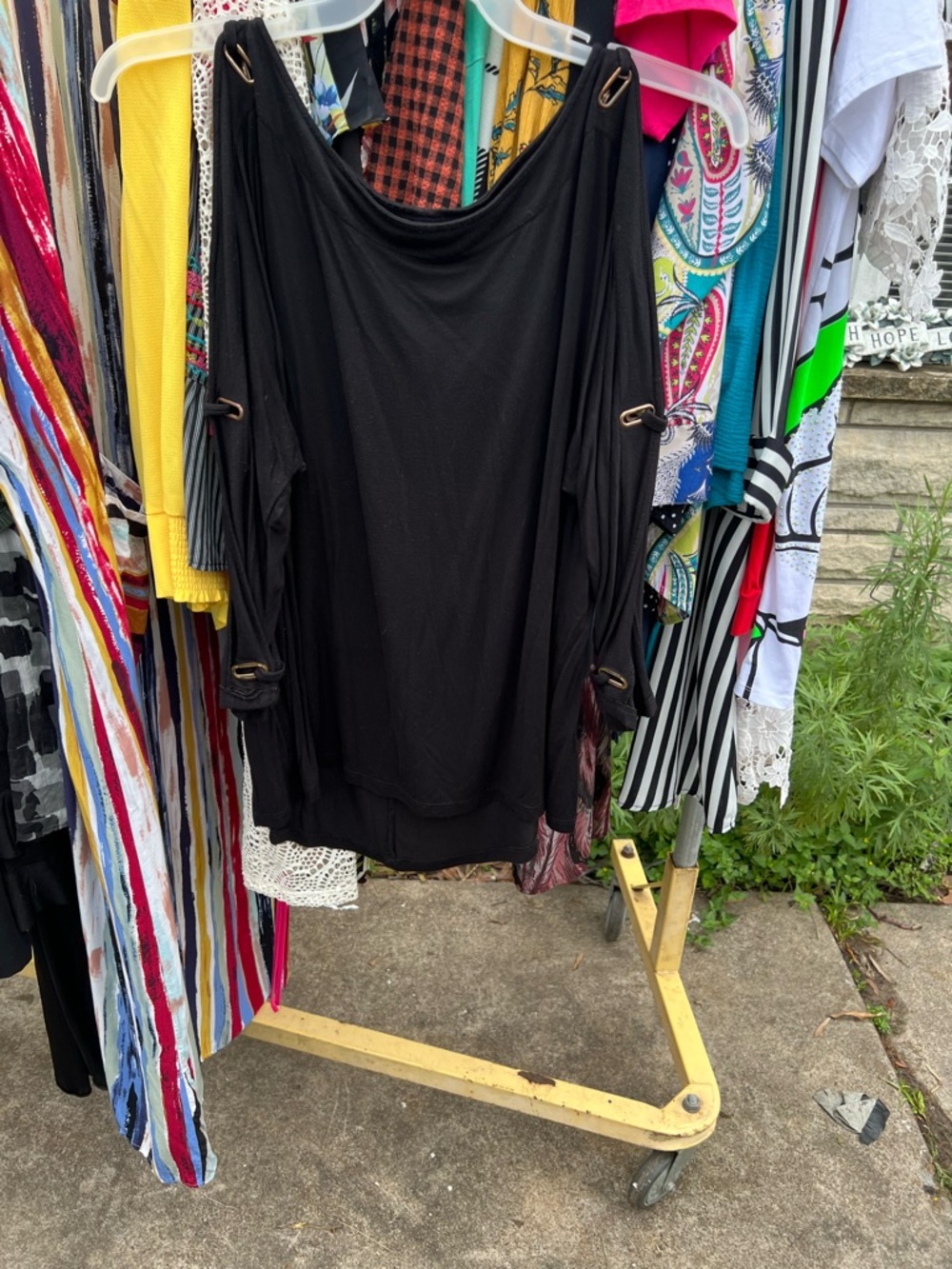 Black top with designs on the sleeves